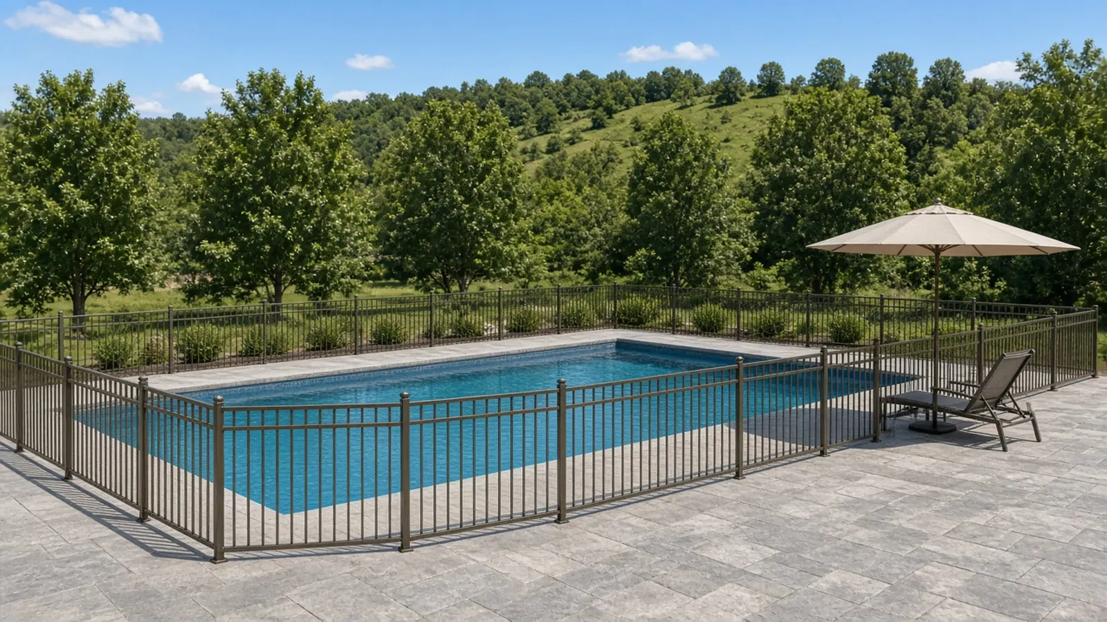 Bronze aluminum pool fence around an in-ground pool with green hills beyond, Murfreesboro, TN