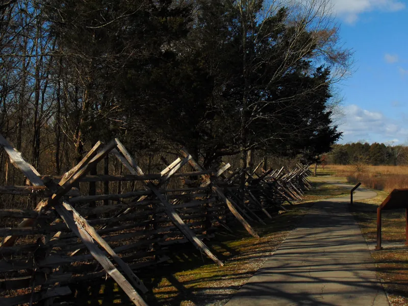 Zigzag split rail fence beside a paved path at Stones River National Battlefield in Murfreesboro